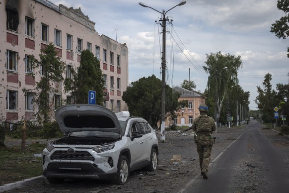 A Ukrainian soldier walks past at a city hall in Sudzha, Kursk region, Russia, Friday, Aug. 16, 2024. This image was approved by the Ukrainian Defense Ministry before publication. (AP Photo)