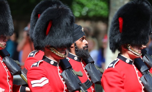 June 9, 2018 - London, London, UK - London, UK. Guardsman Charanpreet Singh Lall (C), the first to wear a black turban instead of a bearskin during Trooping the Colour, parades down The Mall as Royal  ...
