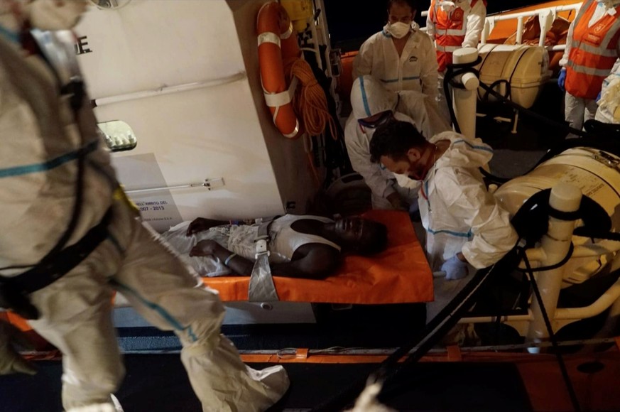 A 22-year-old man from Sub-Saharan Africa is carried on a stretcher off the Sea-Watch 3 ship after having been on board for over fourteen days, one mile outside Lampedusa port on June 28, 2019. SEA-WA ...