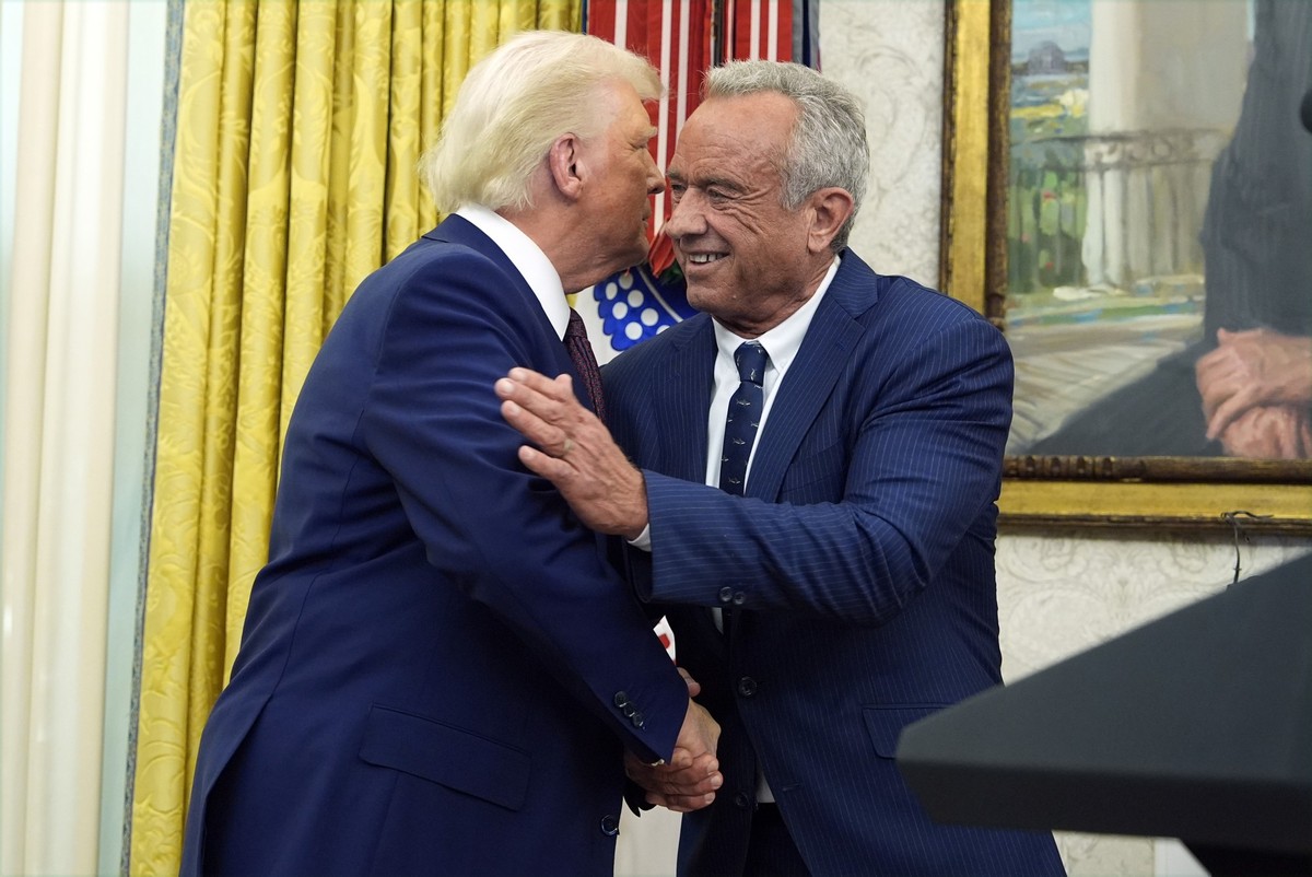 President Donald Trump congratulates Robert F. Kennedy Jr., after he was sworn in as Health and Human Services Secretary in the Oval Office at the White House, Thursday, Feb. 13, 2025, in Washington.  ...
