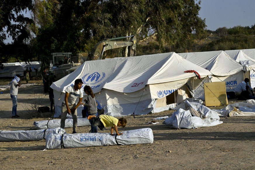 MYTILENE, GREECE - SEPTEMBER 12: Refugee children play in newly built additions to the refugee camp at Kara Tepe in the northeast of the capitol on the Greek island of Lesbos on September 12, 2020 in  ...