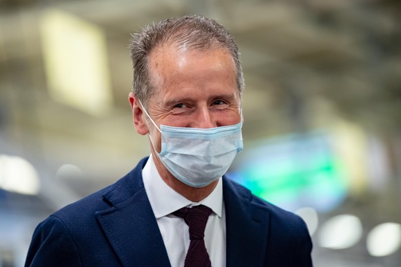 WOLFSBURG, GERMANY - APRIL 27: Herbert Diess, Chairman of the Board of Management of Volkswagen AG wearing a face mask visits the production line at the Wolfsburg Plant on April 27, 2020 in Wolfsburg, ...