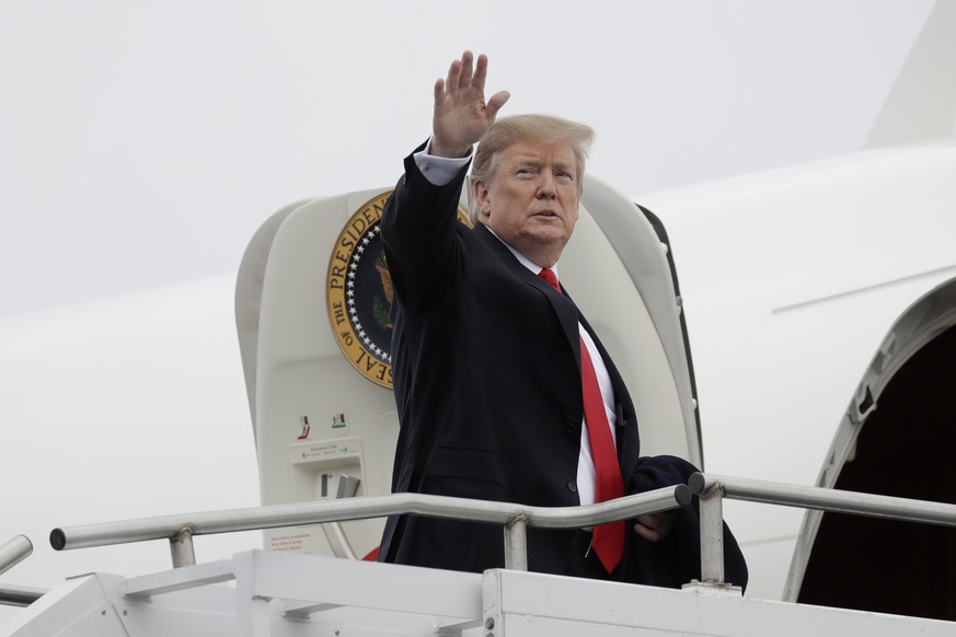 President Donald Trump waves as he boards Air Force One at Lima Allen County Airport. Wednesday, March 20, 2019, in Lima, Ohio. Trump is flying to Canton, Ohio for a fundraising event. (AP Photo/Evan  ...