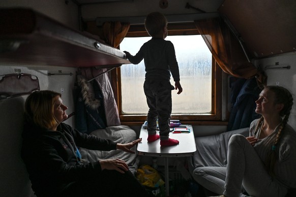 Evacuation Of Civilians From Kherson Continues Young boy Dima plays with his mother Aleksya R and auntie Svetlana L inside an evacuation train from Kherson to Khmelnytskyi at Kherson station, on Sunda ...