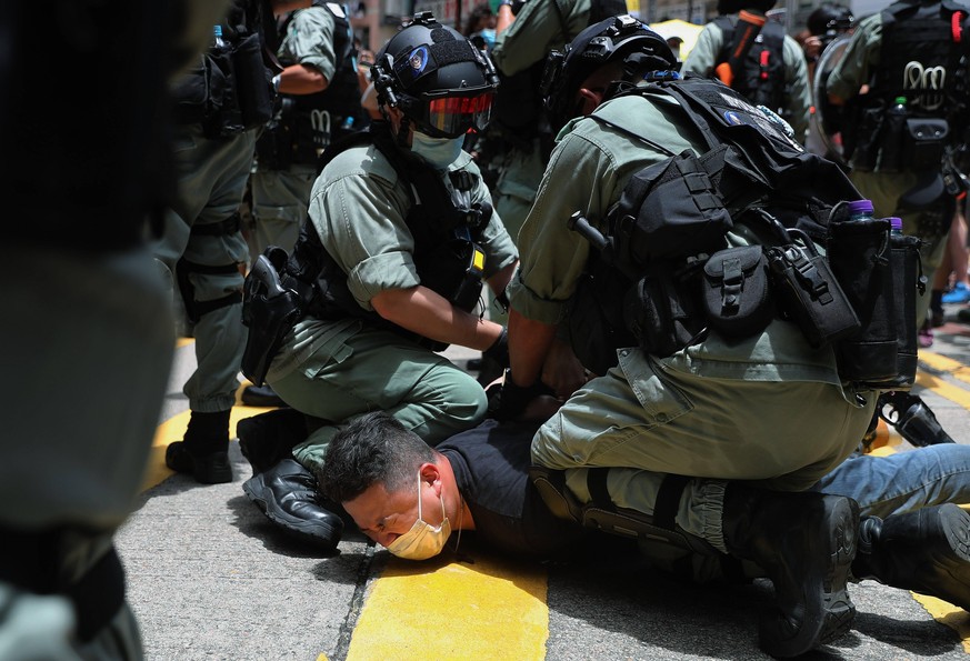 July 1, 2020, Hong Kong, China: An anti-government protestor is detained by police officers in riot gear, during an illegal demonstration on the 23rd anniversary of the establishment of the Hong Kong  ...