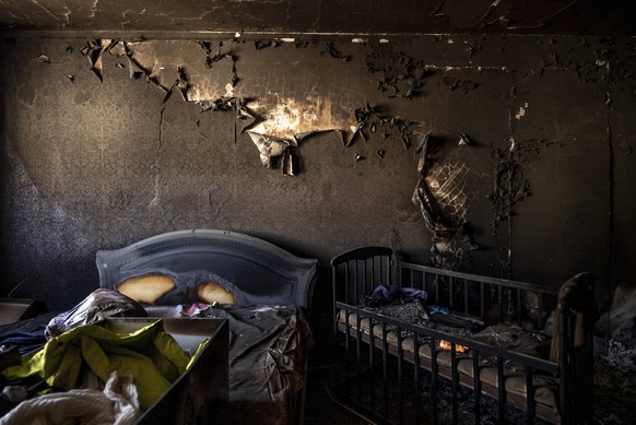 A bed and baby crib are seen in a burned apartment bedroom after Russians shelled the neighborhood in early March in Irpin, Ukraine, Monday, May 09, 2022. The U.K. government has reportedly launched a ...