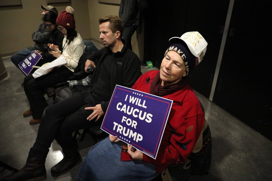 January 14, 2024, Indianola, Florida, USA: Cathy Kurtinitis, of Perry, IA, watches a live feed of former president Donald Trump as he speaks during a rally on Sunday, Jan 14, 2023, at Simpson College  ...