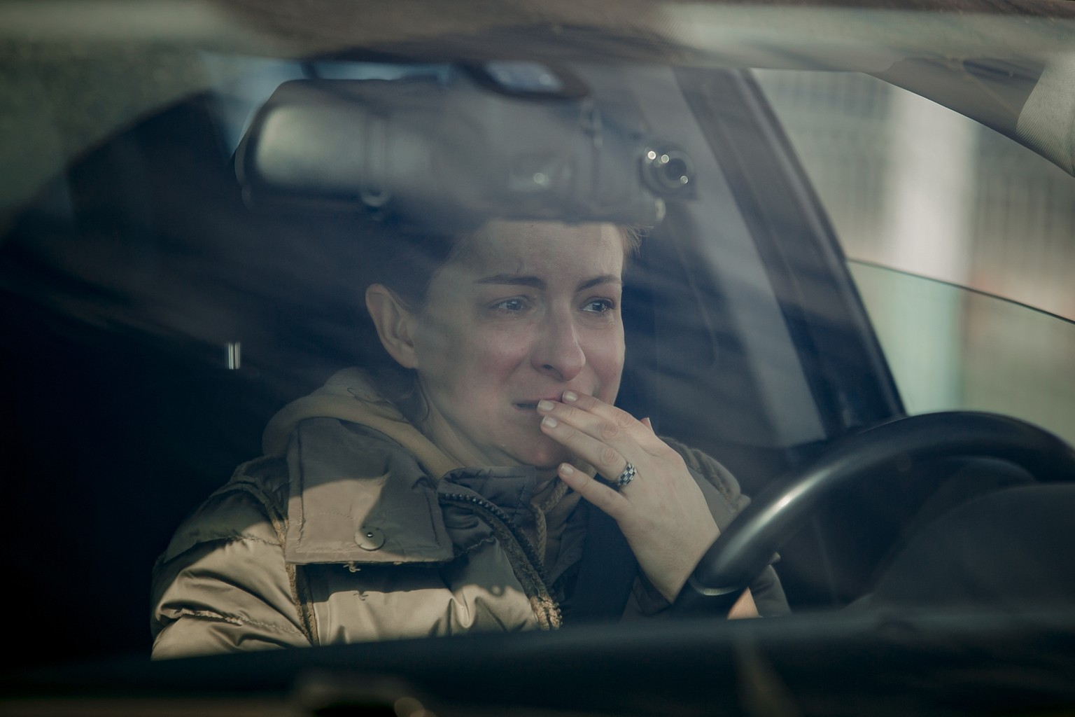 A woman weeps in her car after crossing the border from Ukraine at the Romanian-Ukrainian border, in Sighetu Marmatiei, Romania, Friday, Feb. 25, 2022. Thousands of Ukrainians are fleeing from war by  ...