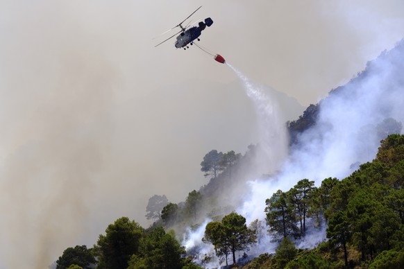 16.07.2022, Spanien, Alhaurin De La Torre: Ein Hubschrauber wirft Wasser ab, um einen Waldbrand in der N�he eines Wohngebiets zu l�schen. Die Waldbr�nde breiten sich in ganz Spanien weiter aus, w�hren ...