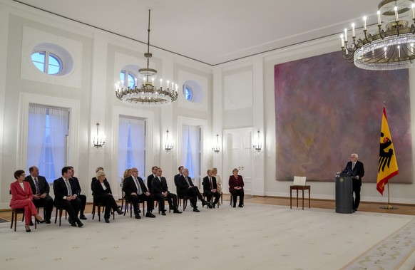 German President Frank-Walter Steinmeier, right, speaks before Chancellor Angela Merkel, 2nd right, and the ministers receive their certificates of dismissal in Berlin, Tuesday, Oct. 26, 2021. Merkel  ...