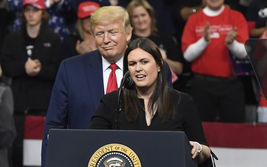 Former White House Press Secretary Sarah Huckabee Sanders is invited to the podium by President Donald Trump during a Keep America Great campaign rally in Des Moines, Iowa, Thursday, January 30, 2020. ...