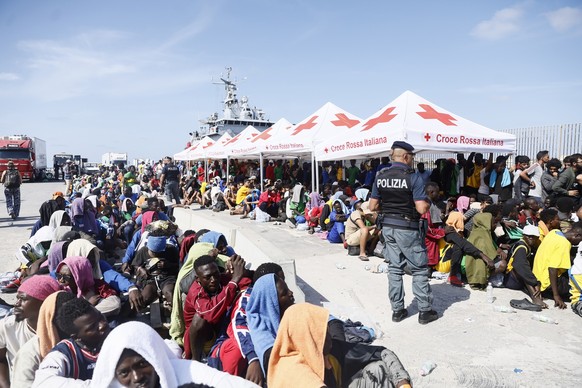 Migrants wait to be transferred from the Lampedusa Island to the mainland, Friday, Sept. 15, 2023. Lampedusa, which is closer to Africa than the Italian mainland, has been overwhelmed this week by tho ...