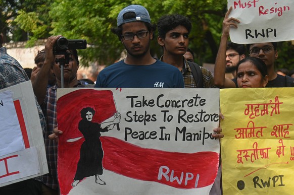July 21, 2023, New Delhi, Delhi, India: Activists hold placards and shout slogans during a protest against the sexual assault of women during the ongoing ethnic clashes in the northeastern state of Ma ...