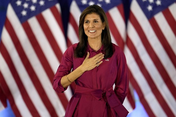 Republican presidential candidate former UN Ambassador Nikki Haley gestures to the audience as she concludes a speech at a caucus night party at the Marriott Hotel in West Des Moines, Iowa, Monday, Ja ...
