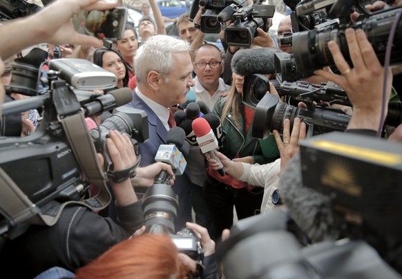 The leader of Romania's ruling Social Democratic party, Liviu Dragnea, is surrounded by media as he arrives at the anti-corruption prosecutors' office, in Bucharest, Romania, Friday, April 27, 2018. D ...
