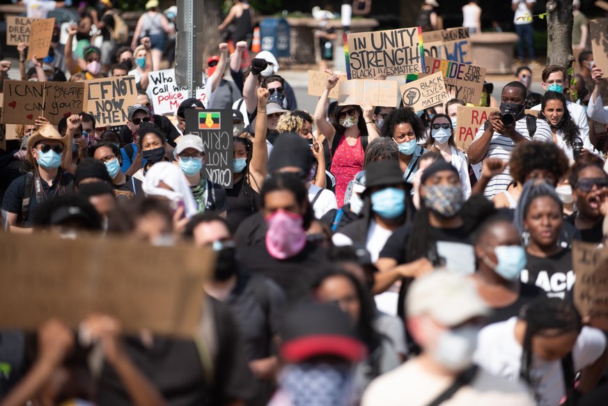 People take part in a demonstration in Washington, United Staets, on June 6, 2020 over the death of George Floyd, a black man who was in police custody in Minneapolis. Floyd died after being restraine ...