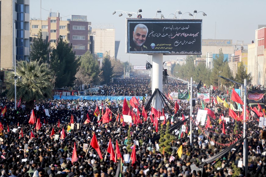 Iranian people attend a funeral procession and burial for Iranian Major-General Qassem Soleimani, head of the elite Quds Force, who was killed in an air strike at Baghdad airport, at his hometown in K ...