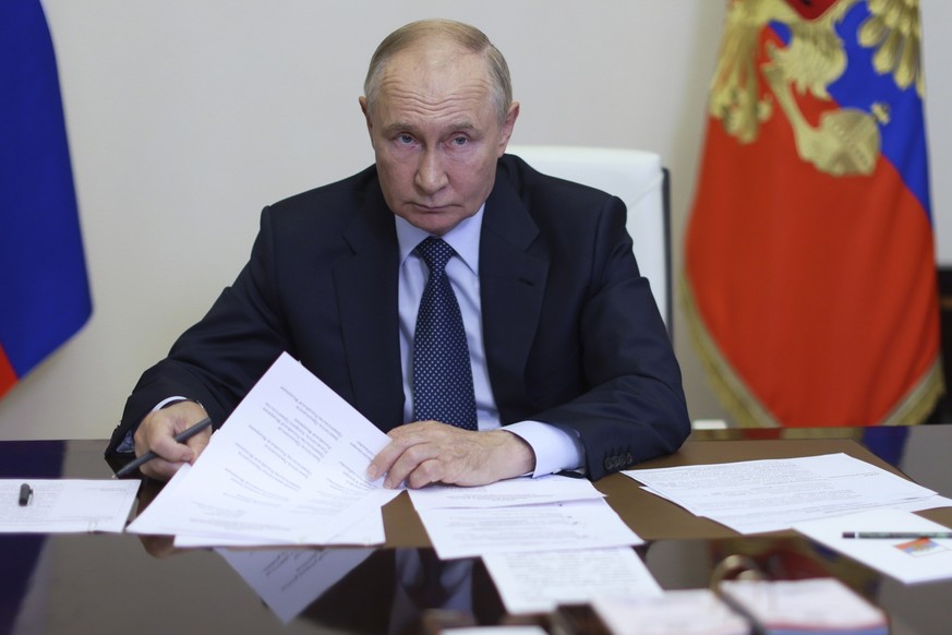 Russian President Vladimir Putin chairs a meeting with members of the government via videoconference at the Novo-Ogaryovo state residence, outside Moscow, Russia, Thursday, Aug. 22, 2024. (Gavriil Gri ...