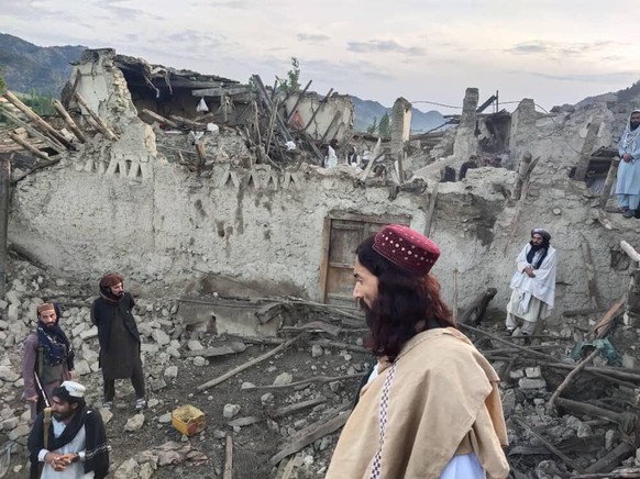 dpatopbilder - HANDOUT - 22.06.2022, Afghanistan, Paktika Province: Auf diesem von der staatlichen Nachrichtenagentur Bakhtar ver�ffentlichten Foto betrachten Afghanen die Zerst�rung durch ein Erdbebe ...