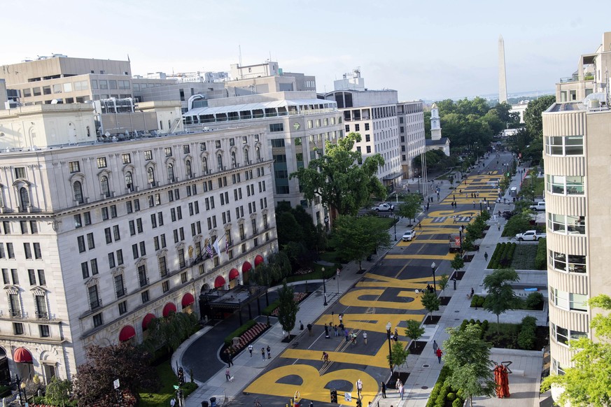 The Washington Monument and the White House are visible behind the words Black Lives Matter sign Saturday, June 6, 2020, that has been painted in bright yellow letters on the 16th Street, in Washingto ...