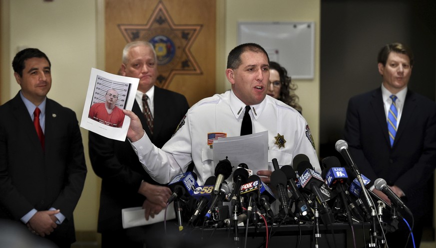 Barron County Sheriff Chris Fitzgerald holds up the booking photo of Jake Thomas Patterson, who allegedly kidnapped Jayme Closs, during a news conference, Friday, Jan. 11, 2018, in Barron, Wis. Closs, ...