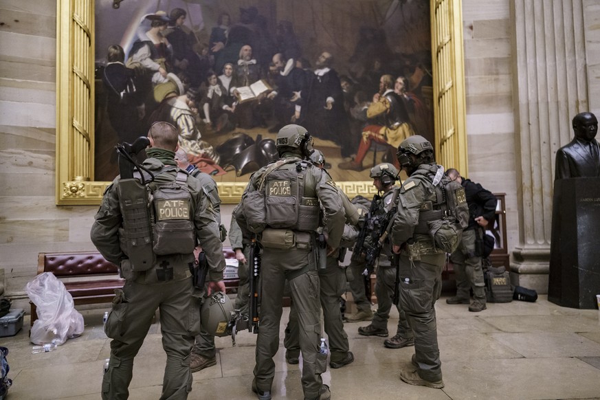 After violent protesters loyal to President Donald Trump stormed the U.S. Capitol today, a tactical team with ATF gathers in the Rotunda to provide security for the continuation of the joint session o ...