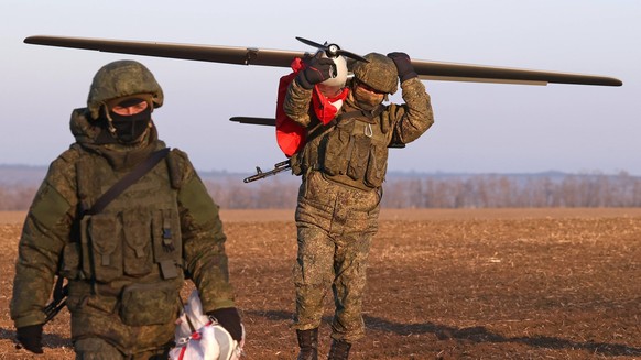 RUSSIA, ZAPOROZHYE REGION - FEBRUARY 8, 2023: A serviceman carries an Orlan-10 unmanned aerial vehicle in the zone of Russia s special military operation. Russian servicemen use the UAV to locate enem ...