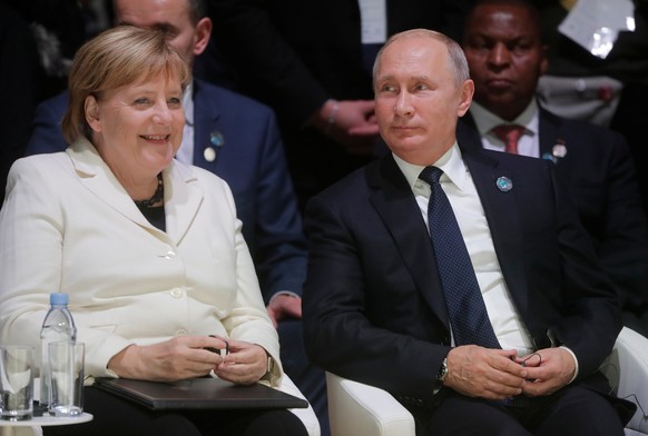 German Chancellor Angela Merkel and Russian President Vladimir Putin attend the opening session of the Paris Peace Forum as part of the commemoration ceremony for Armistice Day, 100 years after the en ...