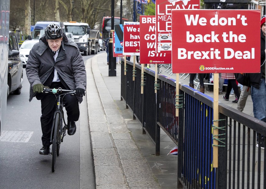 March 27, 2019 - London, UK - BORIS JOHNSON MP passes anti-Brexit placards in Westminster ahead of Prime Minister s Questions. Later today MPs are expected to vote on a series of indicative votes on a ...