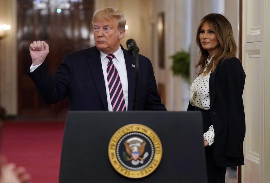 President Donald Trump gestures as he speaks in the East Room of the White House, Thursday, Feb. 6, 2020, in Washington, as first lady Melania Trump looks on. (AP Photo/Evan Vucci)