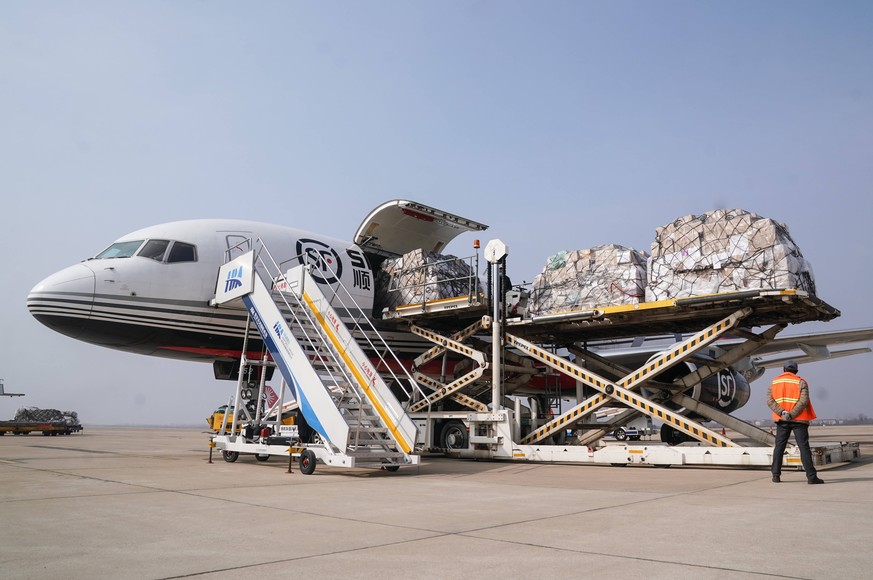 200128 -- WUHAN, Jan. 28, 2020 -- Medical materials are unloaded from a plane at the Wuhan Tianhe International Airport in Wuhan, central China s Hubei Province, Jan. 28, 2020. Three cargo airplanes a ...