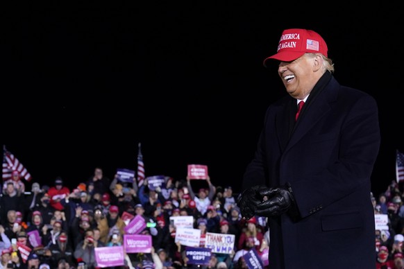President Donald Trump dances after a campaign rally at Gerald R. Ford International Airport, early Tuesday, Nov. 3, 2020, in Grand Rapids, Mich. (AP Photo/Evan Vucci)