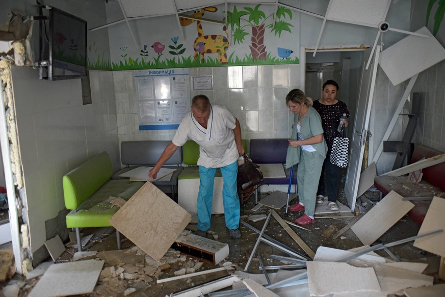 Children s Hospital Hit As Russian Strikes Kill Dozens - Kyiv A doctor accompanies an injured woman at the Ohmatdyt National Specialized Childrens Hospital attacked by Russias Kh-101 strategic cruise  ...