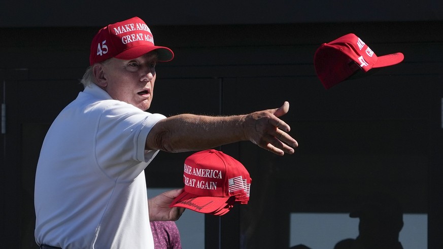 FILE - Former President Donald Trump throws autographed hats to the crowd during the final round of the Bedminster Invitational LIV Golf tournament in Bedminster, N.J., Sunday, Aug. 13, 2023. He&#039; ...