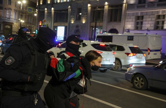 FILE PHOTO: Russian law enforcement officers detain a person during a gathering, after opposition activists called for street protests against the mobilisation of reservists ordered by President Vladi ...