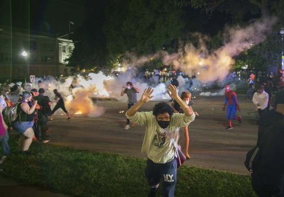 August 25, 2020, Kenosha, Wisconsin, USA: Tear gas lands near protesters after they refused to listen to the demands of police to disperse near the courthouse in Kenosha. Businesses were destroyed, an ...
