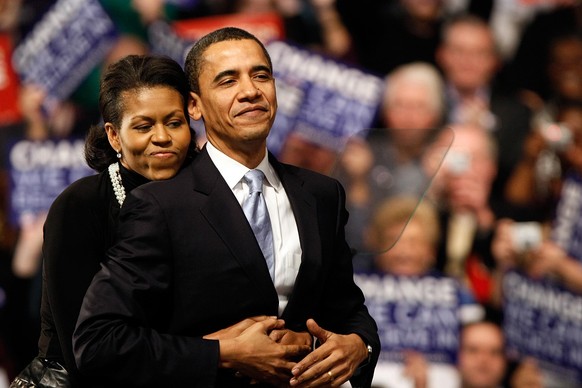 NASHUA, NH - JANUARY 08: Democratic presidential hopeful Sen. Barack Obama (D-IL) is hugged by his wife Michelle Obama before his speech at a primary night rally in the gymnasium at the Nashua South H ...