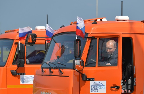 FILE - Russian President Vladimir Putin prepares to drive a truck to officially open the much-anticipated bridge linking Russia and the Crimean peninsula, during the opening ceremony near in Kerch, Cr ...