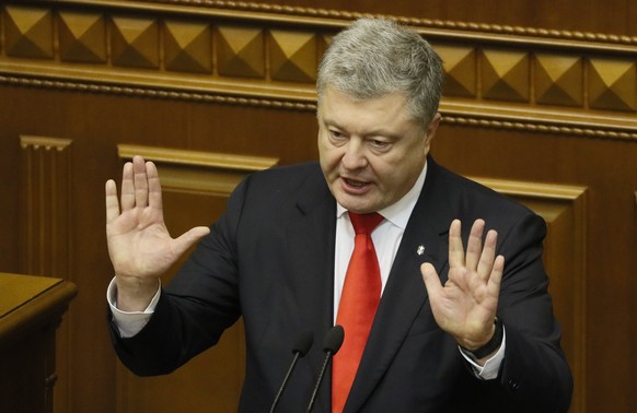 Ukrainian President Petro Poroshenko speaks during a parliament session to review his proposal to introduce martial law for 60 days after Russia seized Ukrainian naval ships off the coast of Russia-an ...
