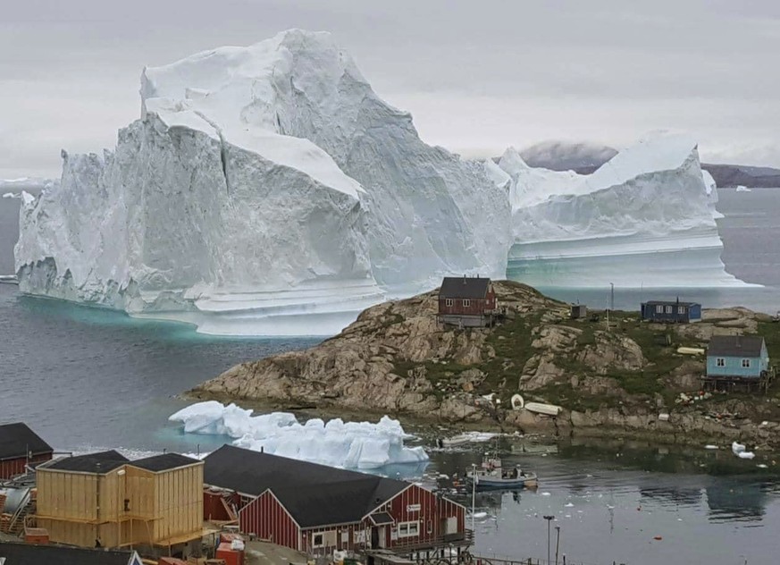 In this Thursday, July 12, 2018 photo, a view of an Iceberg, near the village Innarsuit, on the northwestern Greenlandic coast. Scientists have watched an iceberg four miles long break off from a glac ...