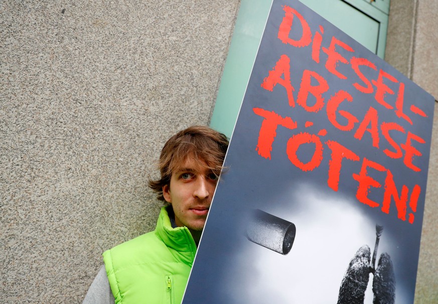 An environmental activist protests in front of a court before a court hearing on case seeking diesel cars ban in Berlin, Germany, October 9, 2018. The sign reads 'Diesel exhaust gases kill.' REUTERS/F ...
