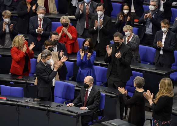 Olaf Scholz of the Social Democrats receives applause from lawmakers after he was elected new German Chancellor in the German Parliament Bundestag in Berlin, Wednesday, Dec. 8, 2021. The election and  ...