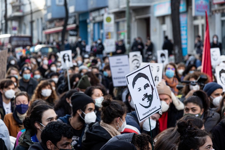 February 20, 2021, Berlin, Germany: Protesters wearing masks march while holding portraits of the victims of the Hanau terror attack during the rally..On the first anniversary of the far-right terror  ...