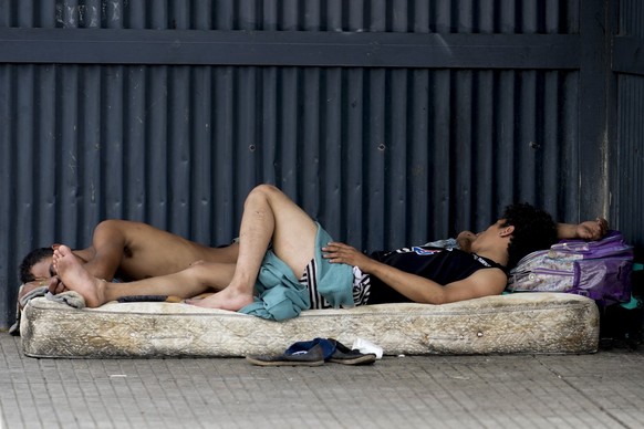 Homeless people sleep on a mattress on the sidewalk in Buenos Aires, Argentina, Wednesday, Dec. 13, 2023. Argentina&#039;s government devaluated the peso by 50%, to 800 to the U.S. dollar from 400 pes ...