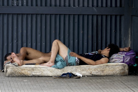 Homeless people sleep on a mattress on the sidewalk in Buenos Aires, Argentina, Wednesday, Dec. 13, 2023. Argentina's government devaluated the peso by 50%, to 800 to the U.S. dollar from 400 pes ...