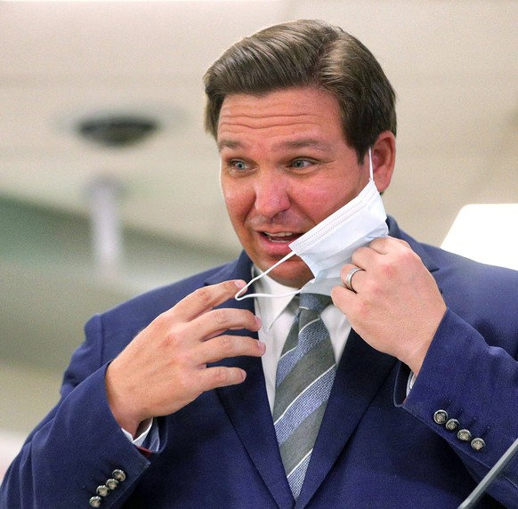January 4, 2021, Longwood, FL, USA: Florida Gov. Ron DeSantis removes his mask to answer questions during a press conference touting the expanded rollout of the Moderna vaccine for the COVID-19 corona ...