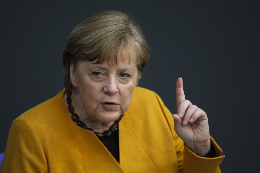 German Chancellor Angela Merkel, center, answers questions from lawmakers at German parliament Bundestag in Berlin, Germany, Wednesday, March 24, 2021. (AP Photo/Markus Schreiber)