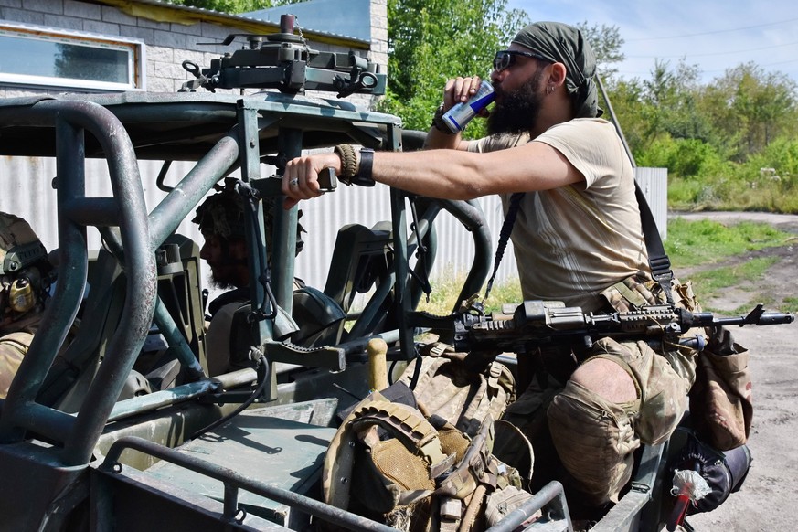 July 19, 2023, Tavriiske, Zaporizhzhia, Ukraine: Ukrainian army soldier seen drinking soda water as they drive towards the frontline on a combat buggy in Tavriiske. Ukrainian armed forces are using bu ...