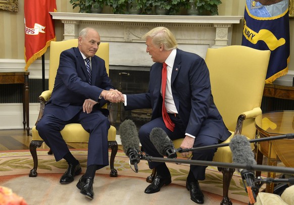 WASHINGTON, D.C. - JULY 31: (AFP-OUT) President Donald Trump (R) shakes hands with new White House Chief of Staff John Kelly after he was sworn in, in the Oval Office of the White House, July 31, 2017 ...