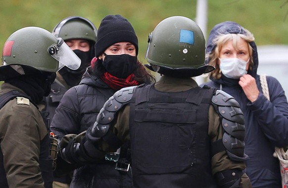 MINSK, BELARUS - NOVEMBER 15, 2020: Law enforcement officers confront participants in the March of the Brave protest event in the city centre, a placard reading My Home Country Drowns in Blood . The A ...